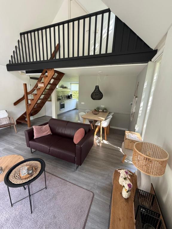 a living room with a couch and a table at Vakantiewoning Sjun Limburg in Simpelveld
