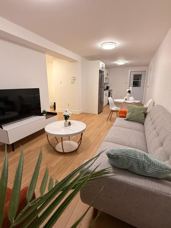 a living room with a couch and a table at Modern 2BR Suite, Wifi, Workstation and Comfy Beds in St. John's
