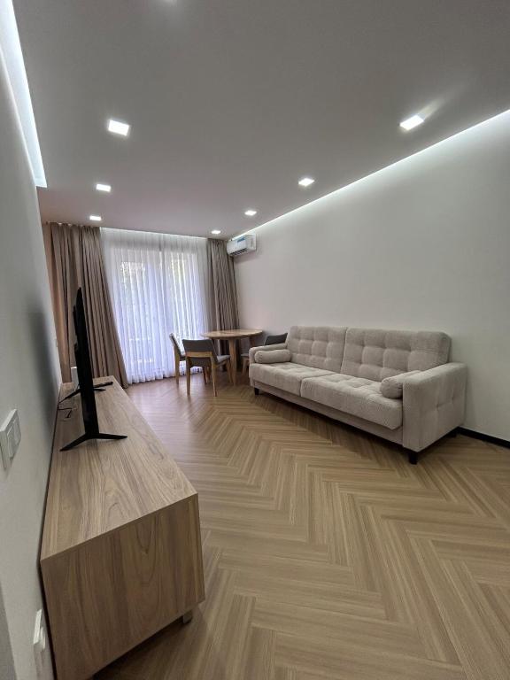 a living room with a couch and a table at Modern Apt in Shymkent