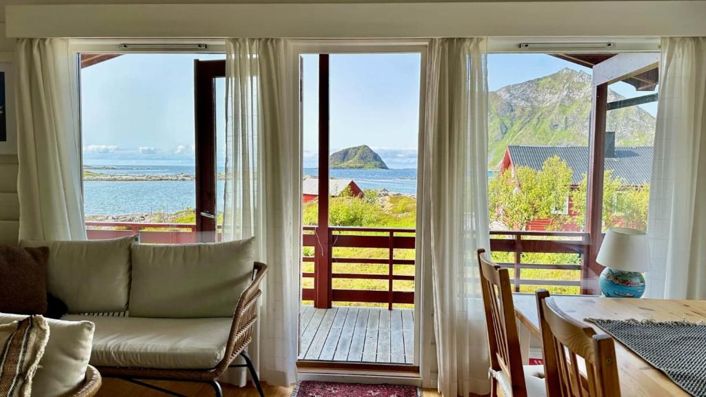 a living room with a view of the ocean at Atlantic Shoreline Cabin in Vestvågøya