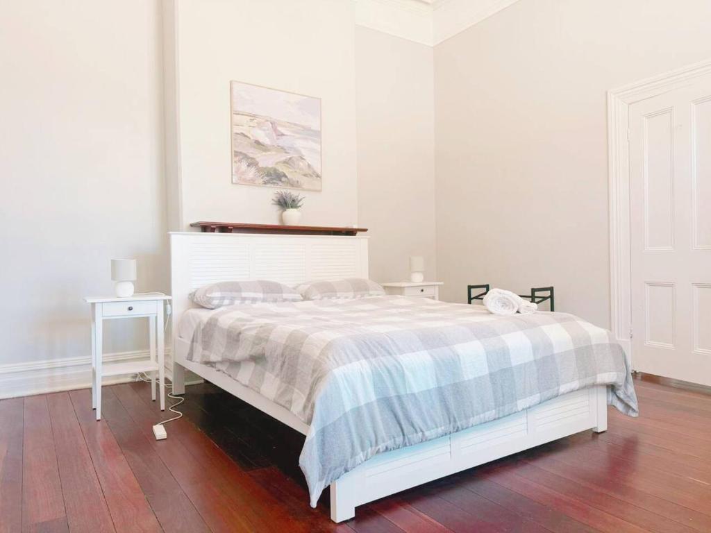 a white bedroom with a bed and a table at Perth property - Heritage Charm Meets Modern Ease close to all amenities including Midland Hospital in Midland Junction