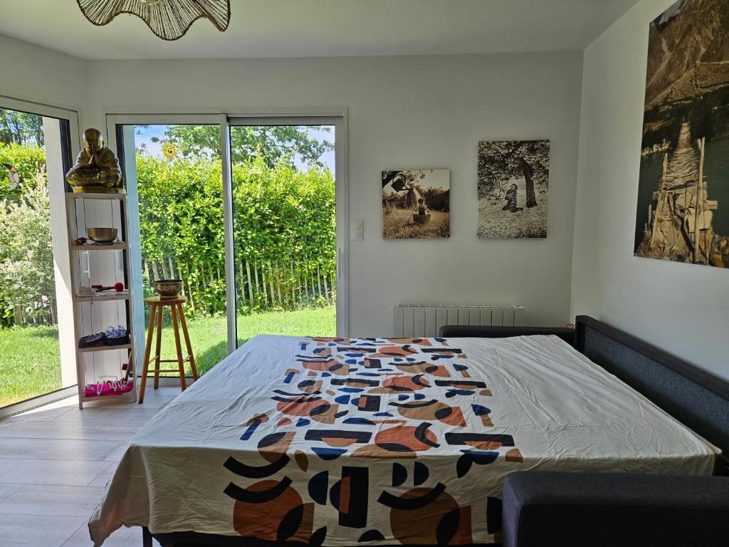 a bedroom with a bed and a large window at Chambre privée proche GR & Véloroute in Plougonvelin