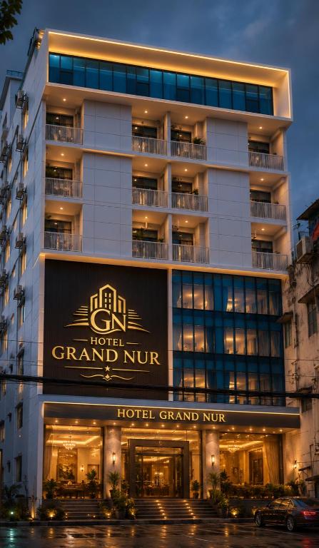 a building with a sign that reads grand inn at HOTEL GRAND NUR, Dhaka in Dhaka
