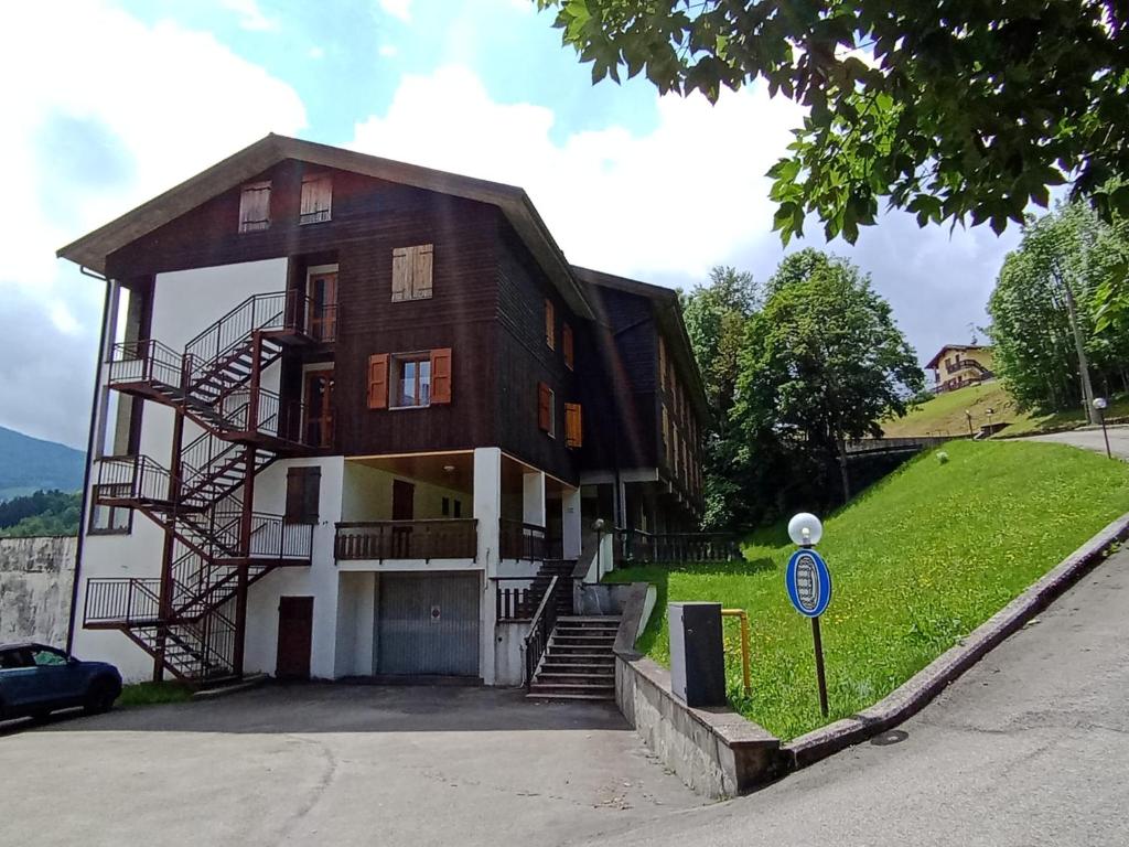 a large house with stairs on the side of it at Appartamento con vista sul Cimone in Fiumalbo