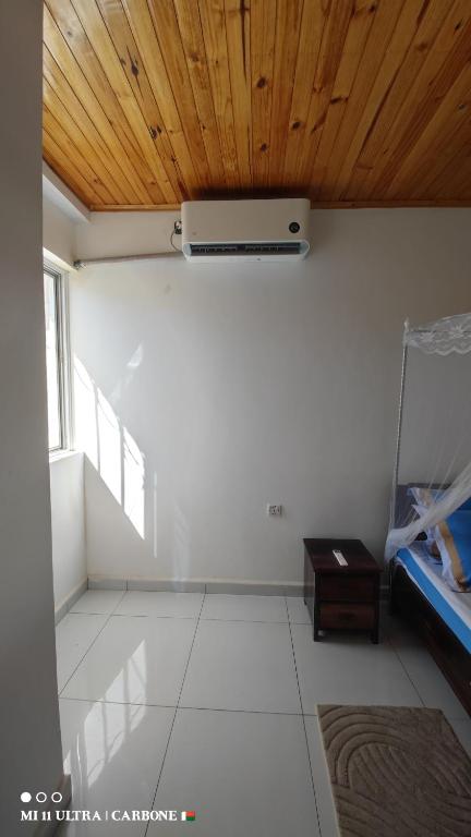 a room with a wooden ceiling with a fan at Forest Hotel in Miarinarivo