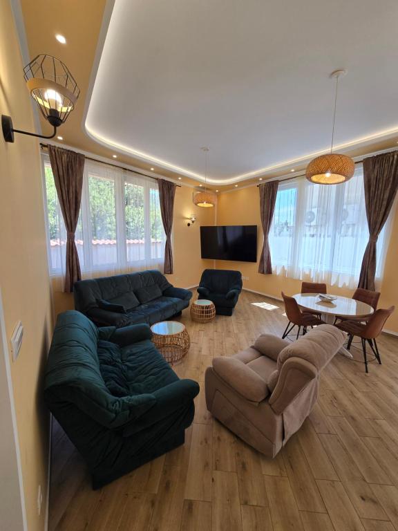 a living room with couches and a dining room at Villa Iper Krystallos in Budva