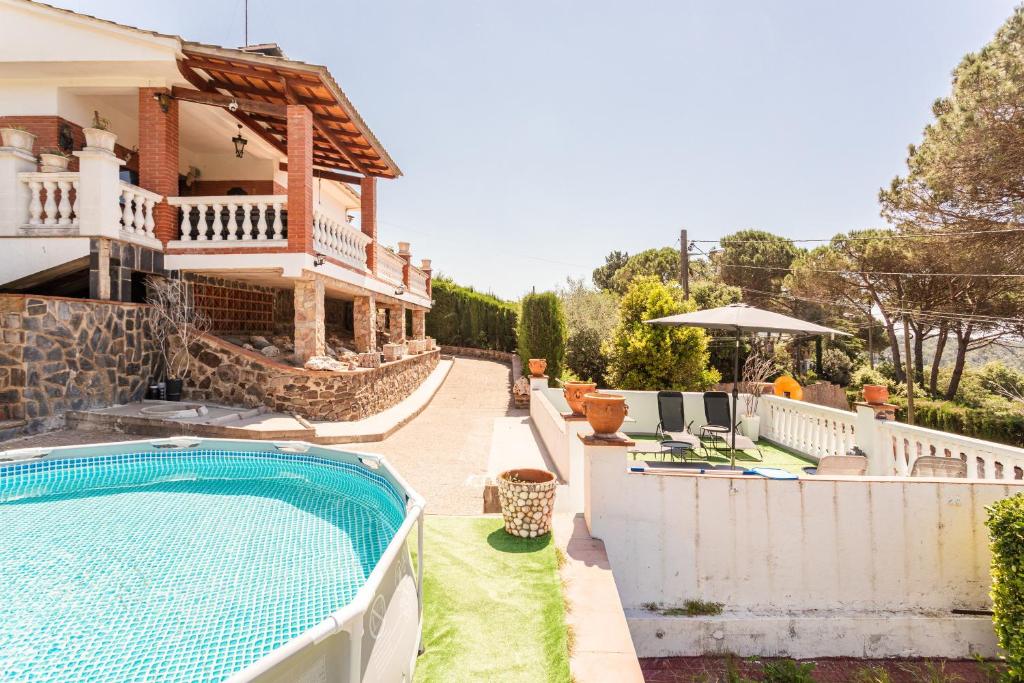 a villa with a swimming pool and a house at Villa Toro in Maçanet de la Selva