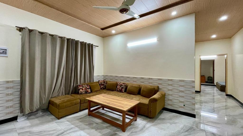 a living room with a couch and a table at 2 Bed Apartment With View in Patriata
