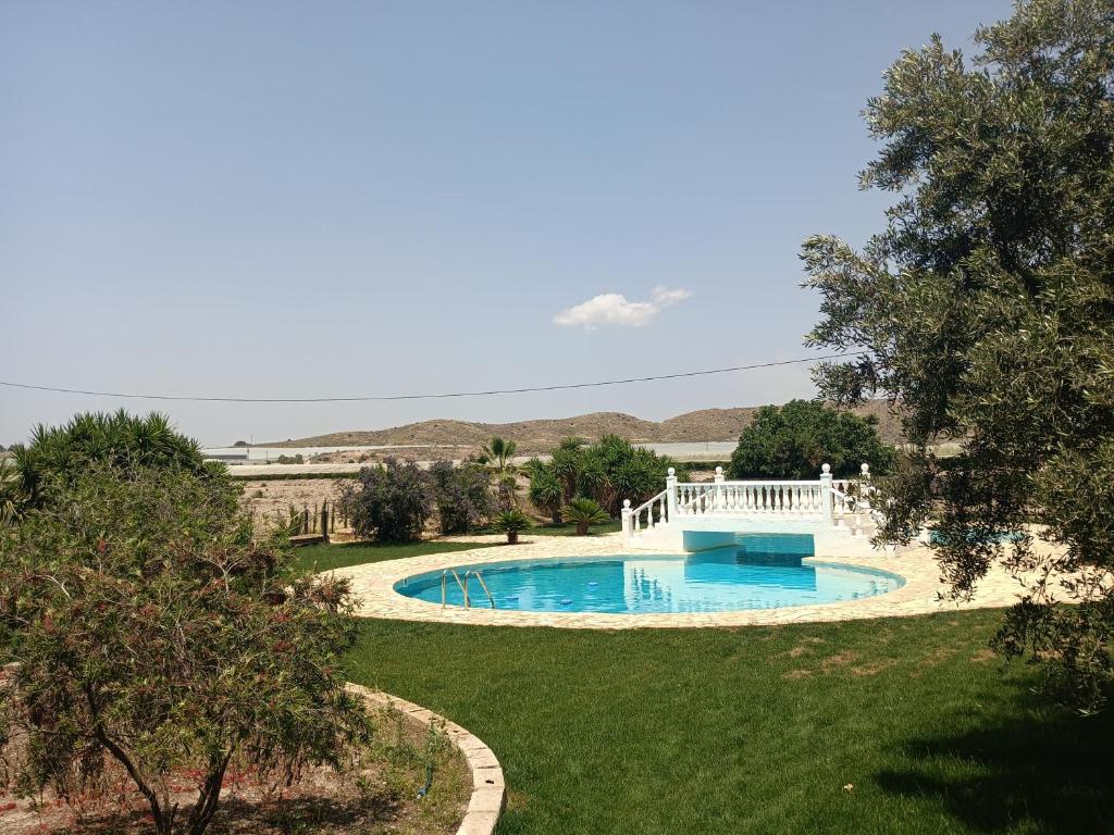 a swimming pool in the middle of a yard at Guest Wing at Casa Africa in Lorca
