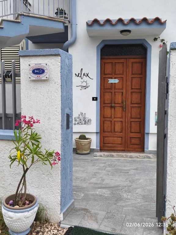 a door of a house with a plant in front at B&B Relax Gonone in Cala Gonone