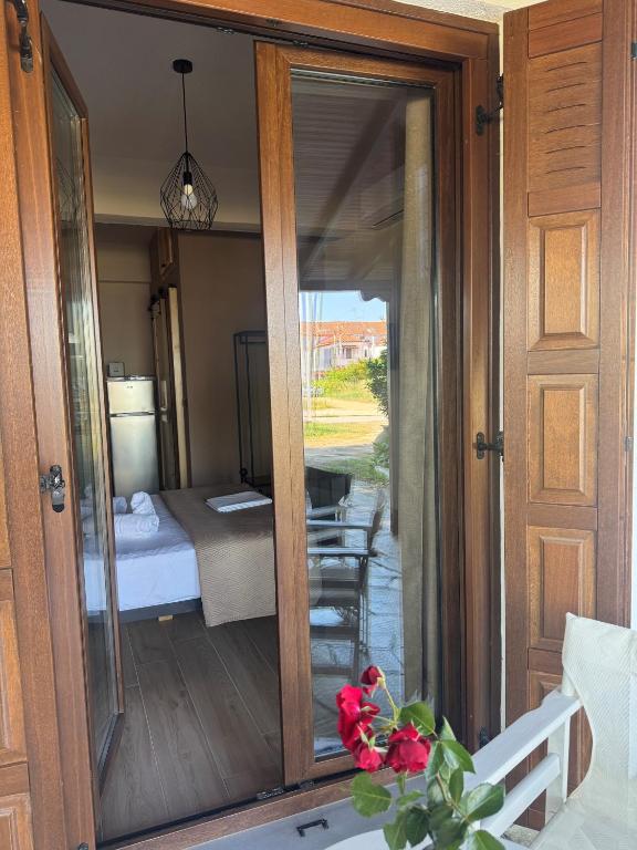 a room with a sliding glass door with a view of a bedroom at Eudokia's House Platanias in Platanias