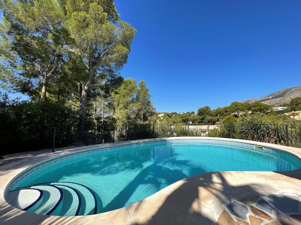 a swimming pool in a yard with trees at Casa Les Fremeaux in Altea