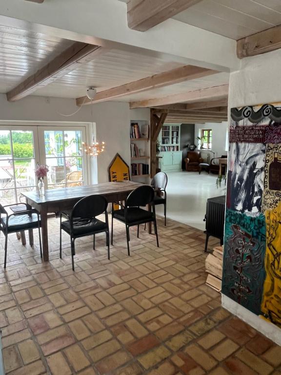 a dining room with a large table and chairs at The Fishermen's House - charming and close to beach in Thisted
