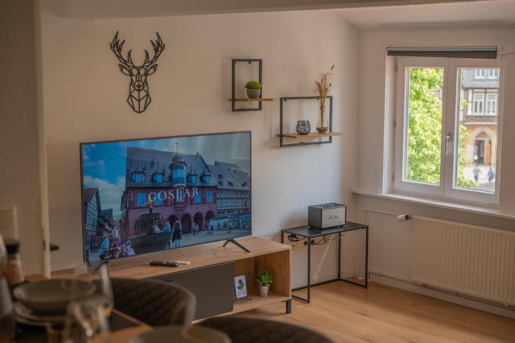 a living room with a large flat screen tv at Goslar LIVING 1 - Modern & Zentral in Goslar