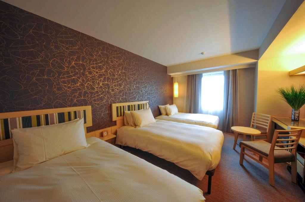 Un ou plusieurs lits dans un hébergement de l'établissement Hotel Resol Trinity Kanazawa