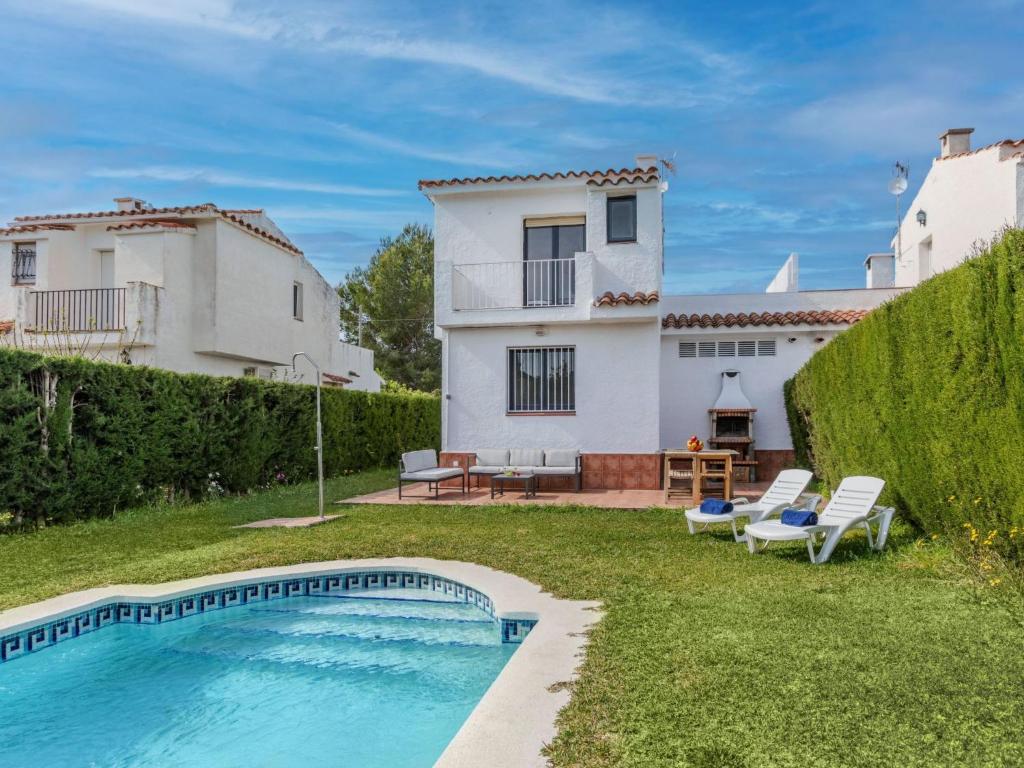 a villa with a swimming pool in front of a house at Villa Calas III by Interhome in L'Ametlla de Mar