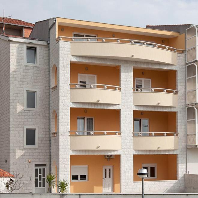 an apartment building with balconies on the side of it at Apartments Villa Vujcic in Makarska