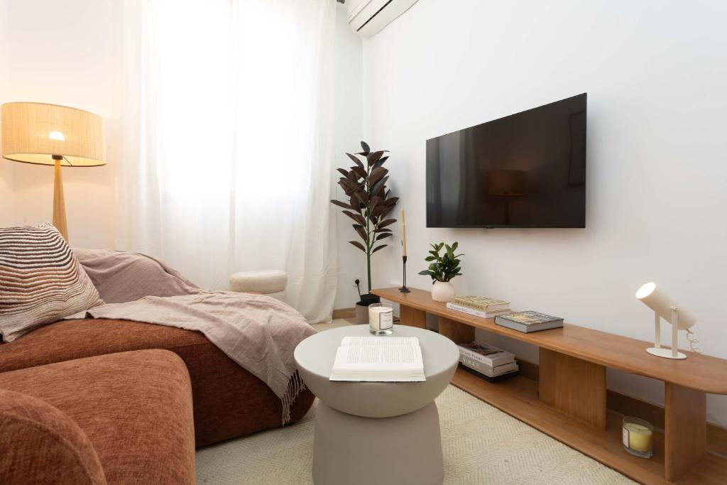 a living room with a flat screen tv on a wall at Barbieri III in Madrid