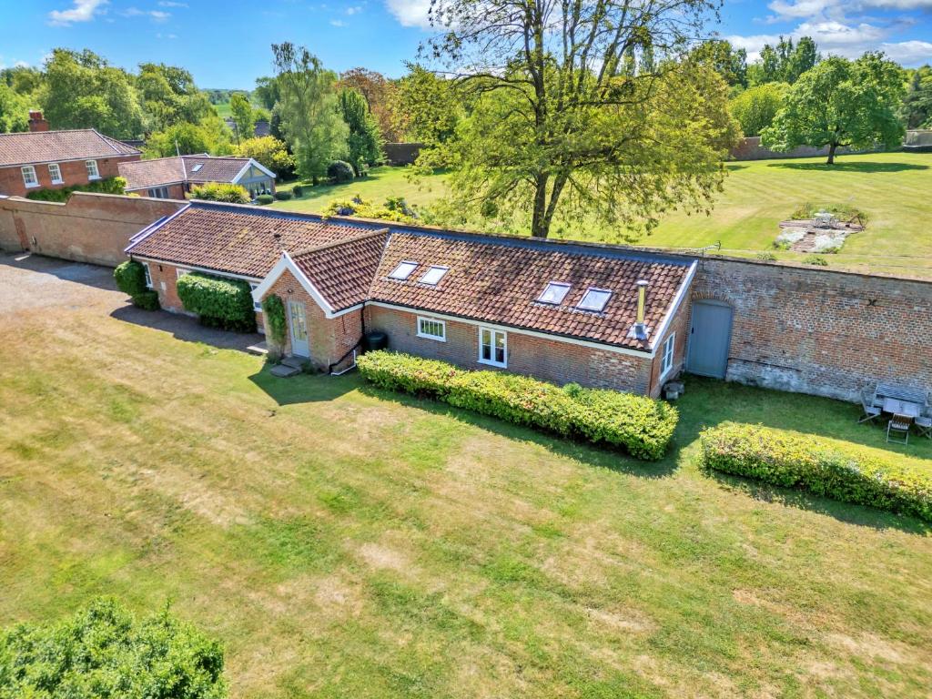 an aerial view of a brick house with a yard at Finest Retreats - The Pottage in Yaxley