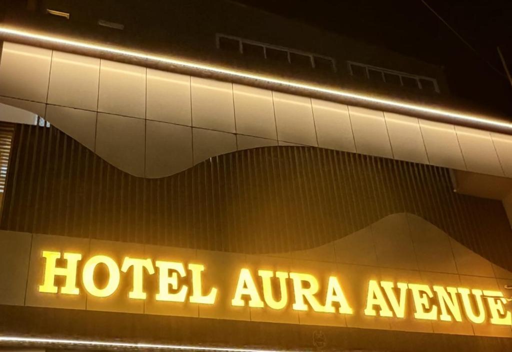 a sign on the side of a hotel entrance at Hotel Aura Avenue in Bathinda