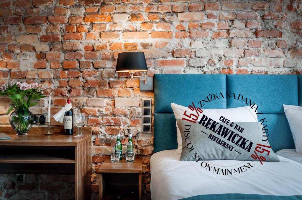a room with a bed and a brick wall at Liberum Residence Old Town in Gdańsk