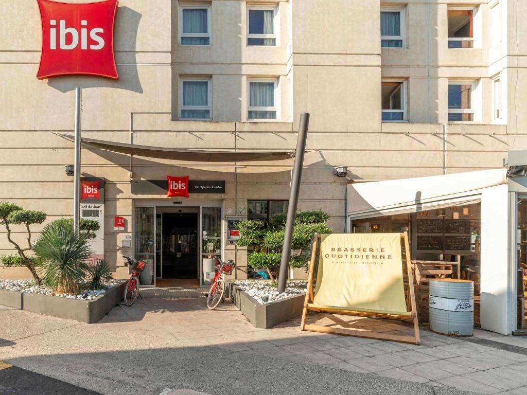 a sign sitting in front of a building at ibis Montpellier Centre Polygone in Montpellier