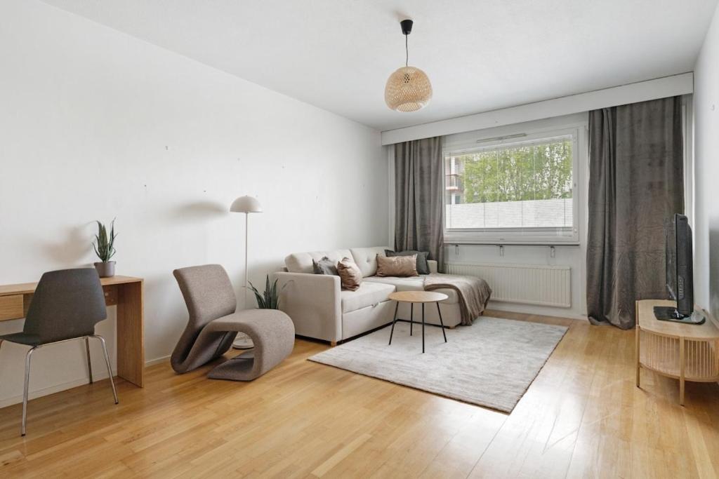 a living room with a couch and a table at Central Lapland Apartment By Lapland Host in Rovaniemi
