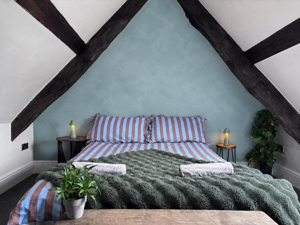 a bedroom with a large bed in a attic at The Eaves - Pen Y Fan Views in Brecon