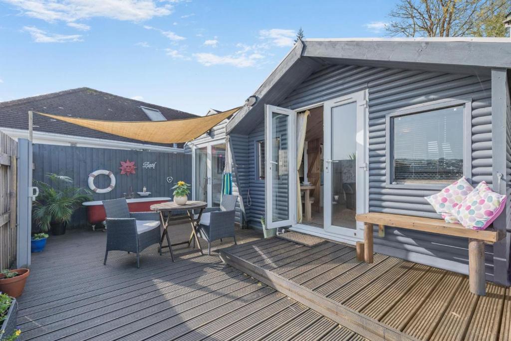 a grey tiny house with a wooden deck at 1 Bed in Totnes oc-bc1000 in Totnes