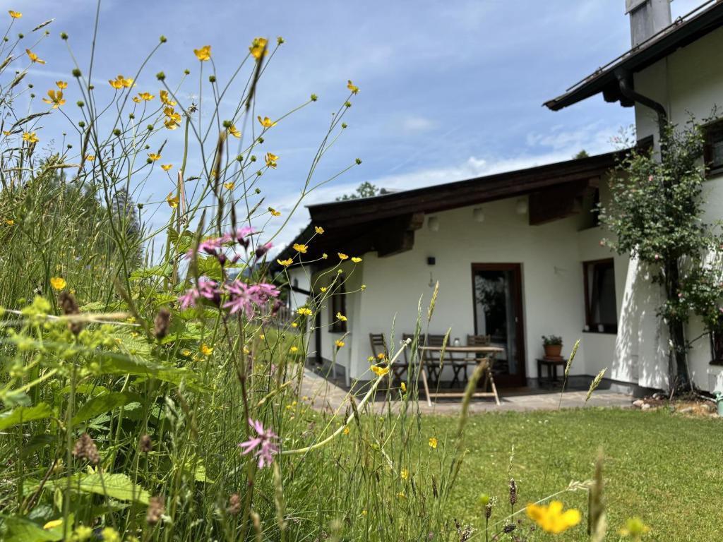 a garden with flowers in front of a house at Bergnest Fieberbrunn in Fieberbrunn