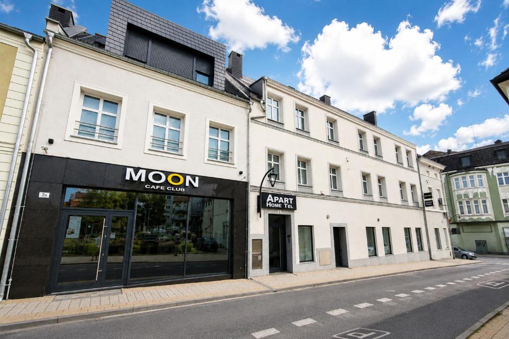 a building with a moon store on a street at Apart Home Tel AHT in Krapkowice
