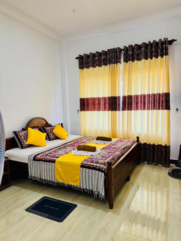 a bedroom with a large bed and a curtain at Grand Infinite Home Stay in Kandy