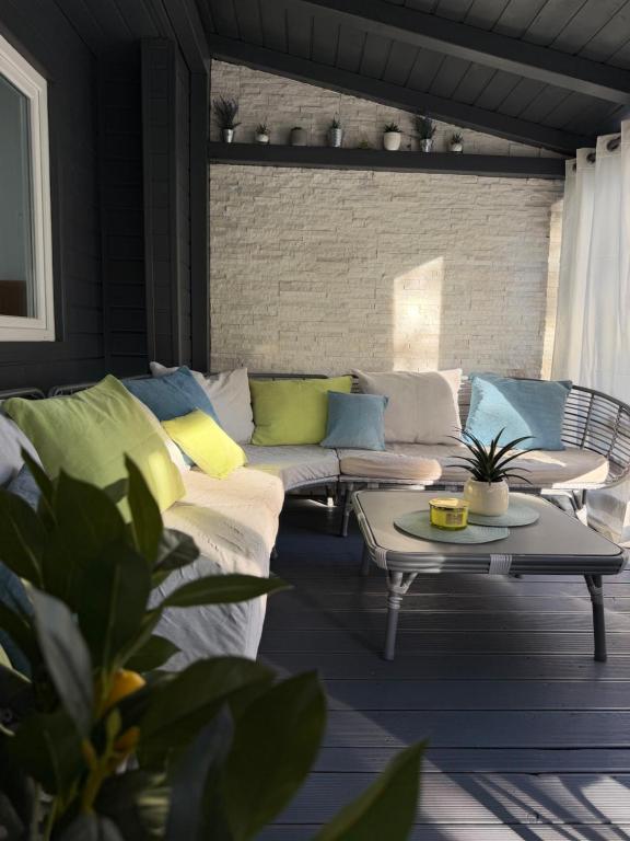 a patio with a couch and a table at Holiday Home Orsag in Drage