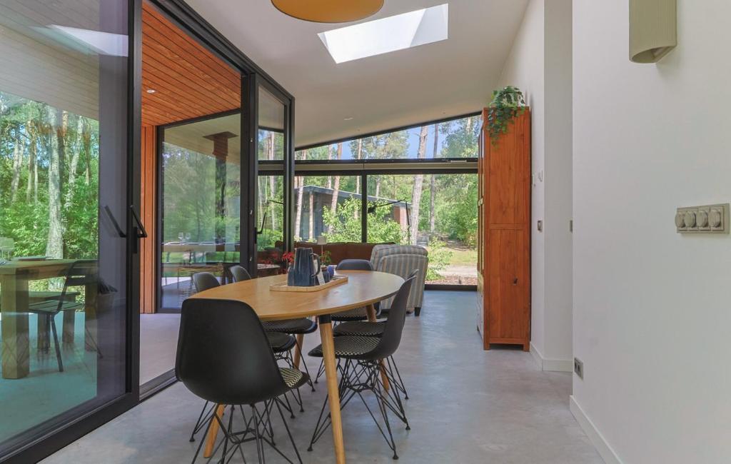 a dining room with a table and chairs at De Rode Vos - Enjoyment in the forest in Giethmen