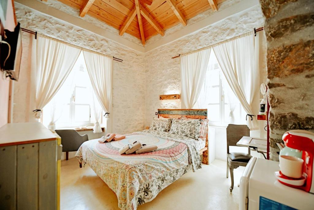 a bedroom with a bed with two shoes on it at Mastoris Mansion in Hydra