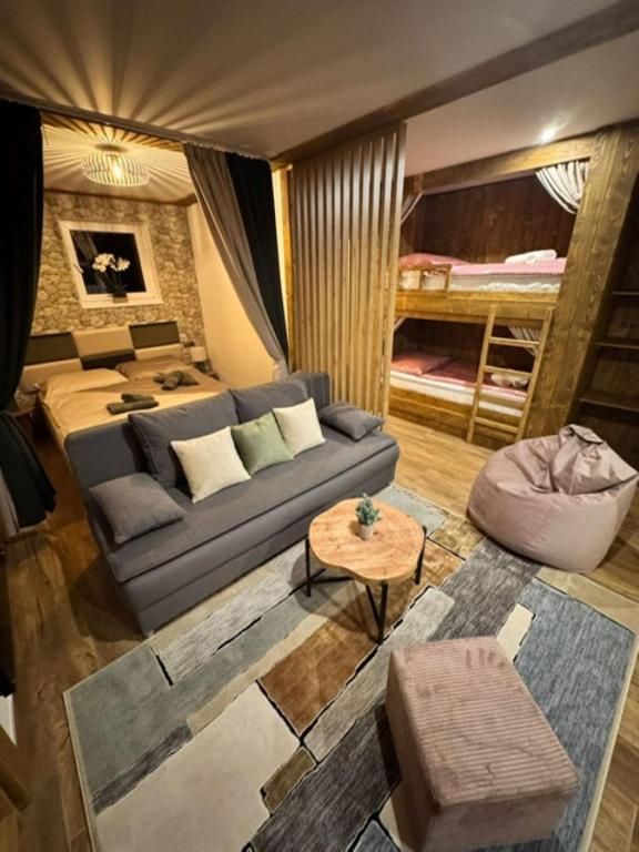 a living room with a couch and a bunk bed at Chata Biela Stopa in Tatranská Lomnica