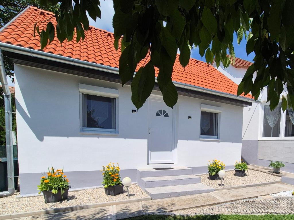 a white house with an orange roof at Auszeit in Balatonmagyaród