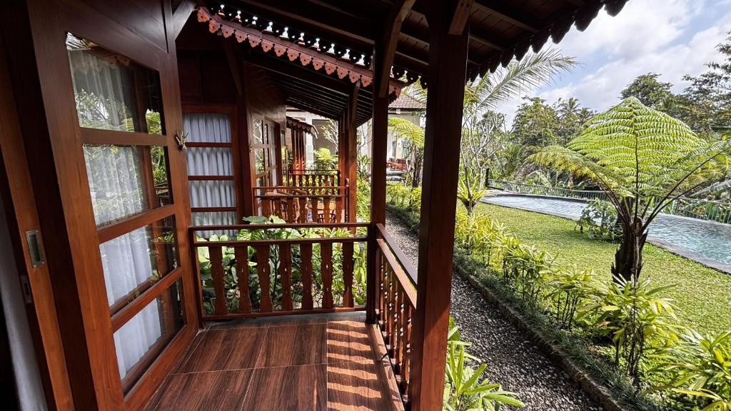 an open door to a house with a garden at ChannaS villas in Payangan