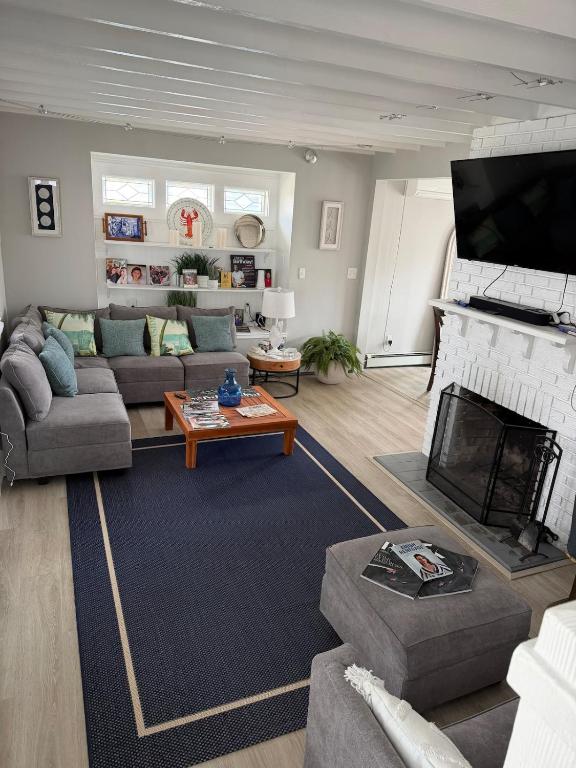 a living room with a couch and a fireplace at 2 bedroom beachfront fully refurbished home in East Haven