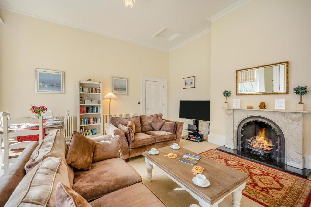 a living room with a couch and a fireplace at 2 Bed in Beadnell oc-4641 in Beadnell