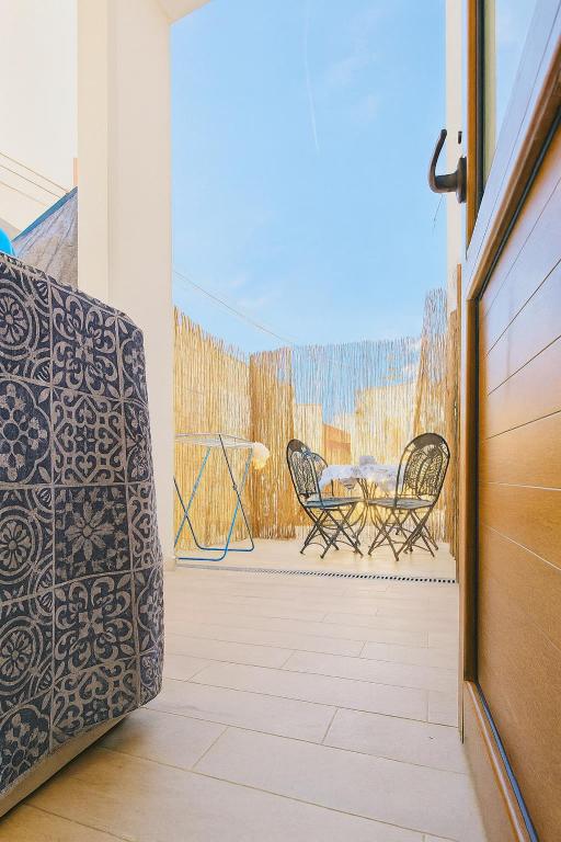 a patio with a table and chairs on a balcony at Mediterraneum - Loft in Sannicola