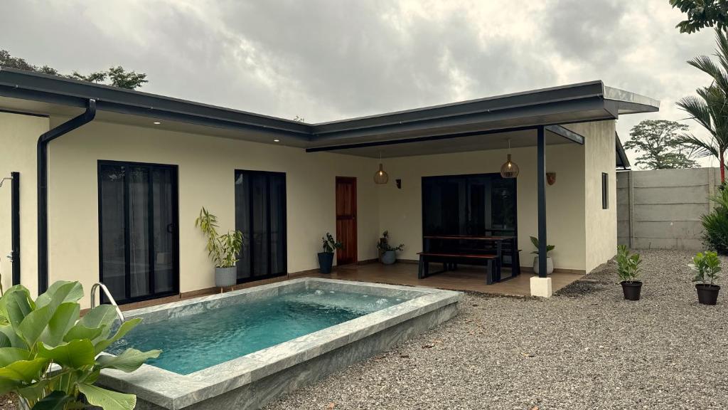 a swimming pool in the backyard of a house at Villa Shambala Arenal Volcano View Private Pool 6 Guests in Tanque