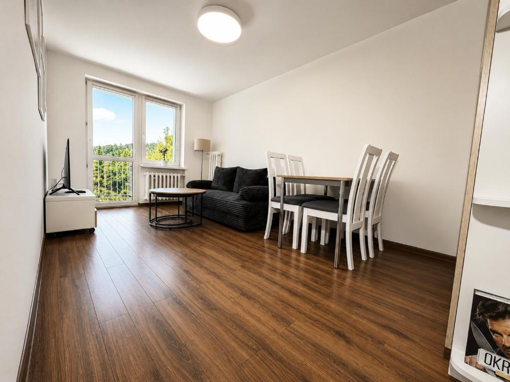 a living room with a table and a couch at Apartament Wisła Centrum in Wisła