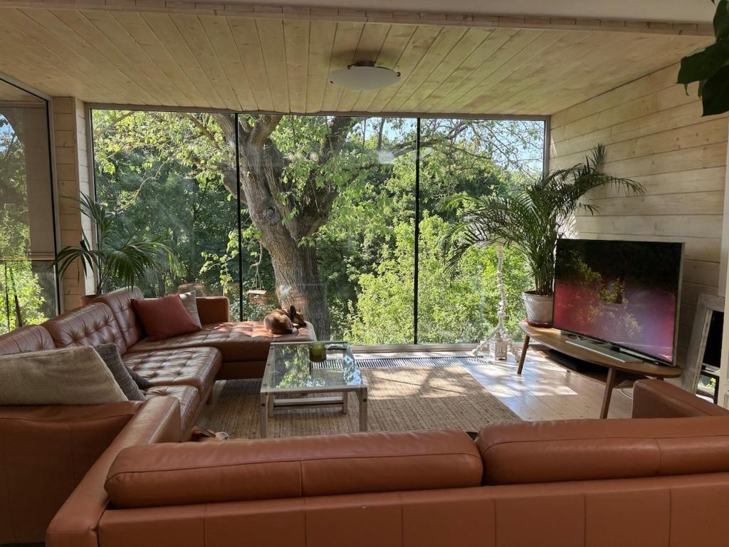 a living room with a couch and a large window at Gallery loft Myjava Hrachoviste in Hrachovište