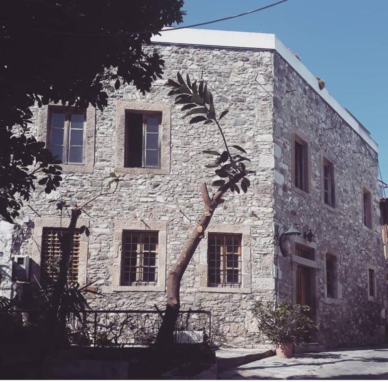 a stone building with a tree in front of it at Old Town Tower House in Kos