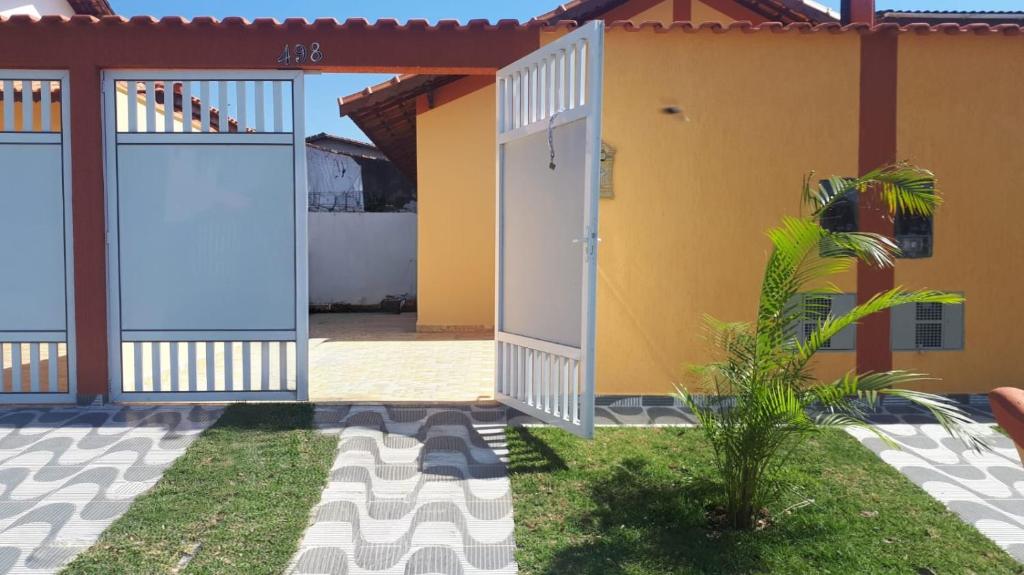 a house with two doors and a courtyard at Casa Martinez in Mongaguá