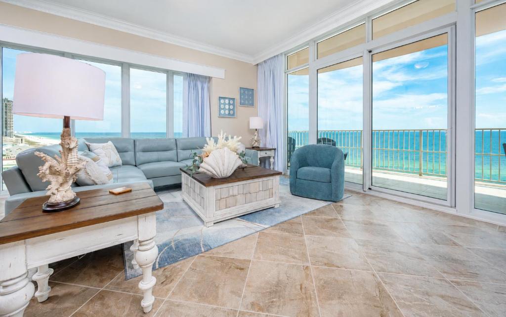 a living room with a couch and a table at Phoenix Gulf Towers 1008 condo in Gulf Shores