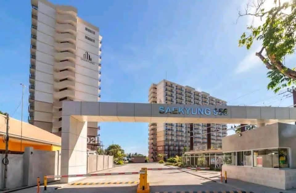a rendering of a building with a sign over a street at Studio Type Furnished Condo in Lapu Lapu City