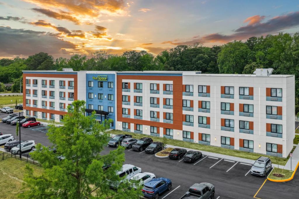 an aerial view of a building with a parking lot at YourSpace Hotels Chesapeake in Chesapeake