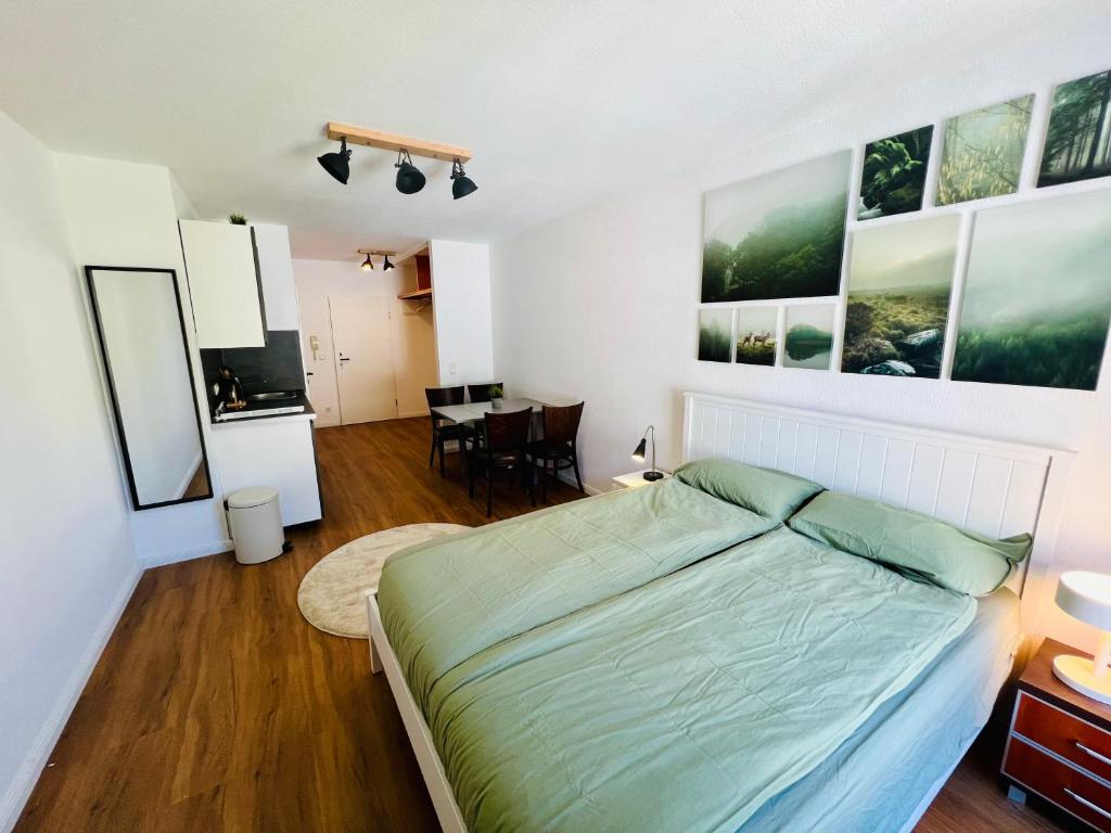 a bedroom with a bed and a dining room at Apartment Altstadt Stralsund in Stralsund
